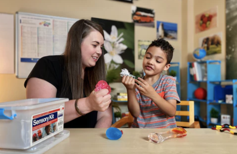 Teacher and student playing with sensory fidget toys