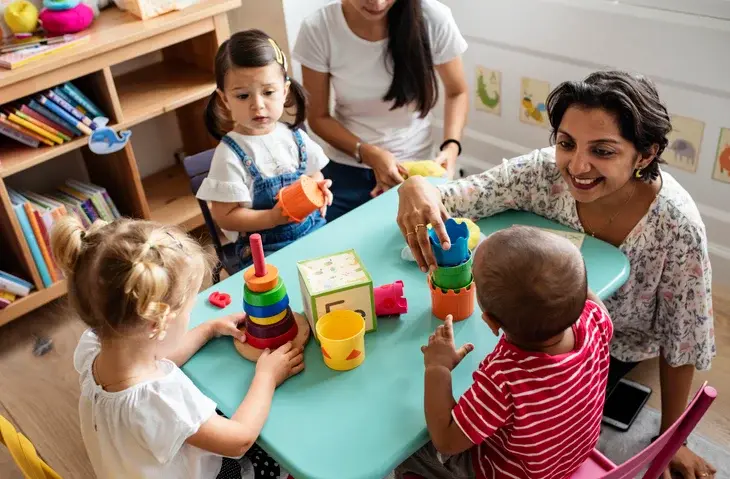 Children with autism and their teacher using ARIS materials in a special-education classroom